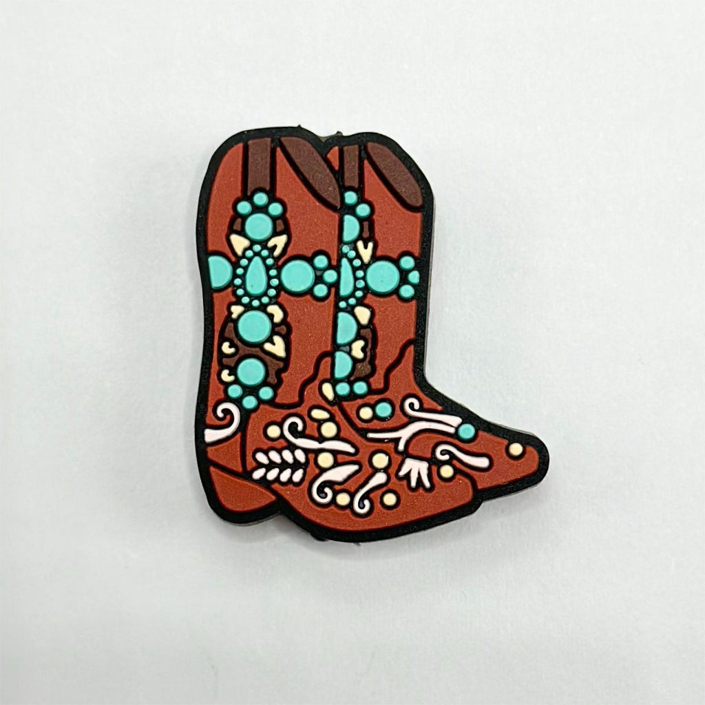 A silicone bead in the shape of a boot with a colorful geometric pattern.

