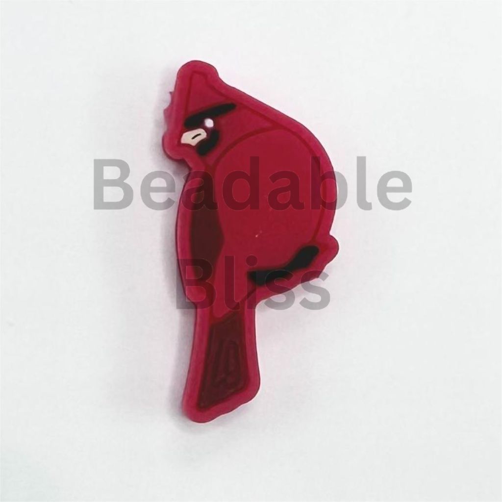 Red cardinal bird-shaped object on a white background

