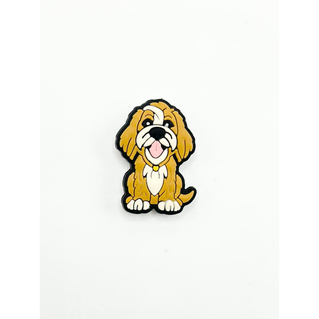A silicone bead in the shape of a cute little yellow puppy with a red collar.


