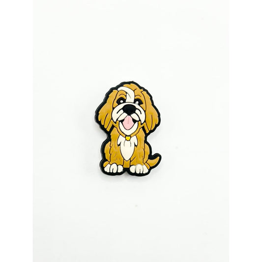 A silicone bead in the shape of a cute little yellow puppy with a red collar.

