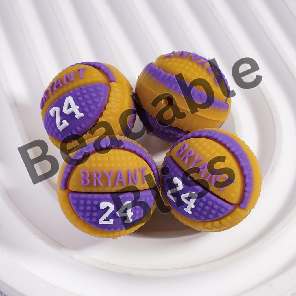 Four purple and yellow basketball-shaped beads with 'Bryant 24' text on a white background.
