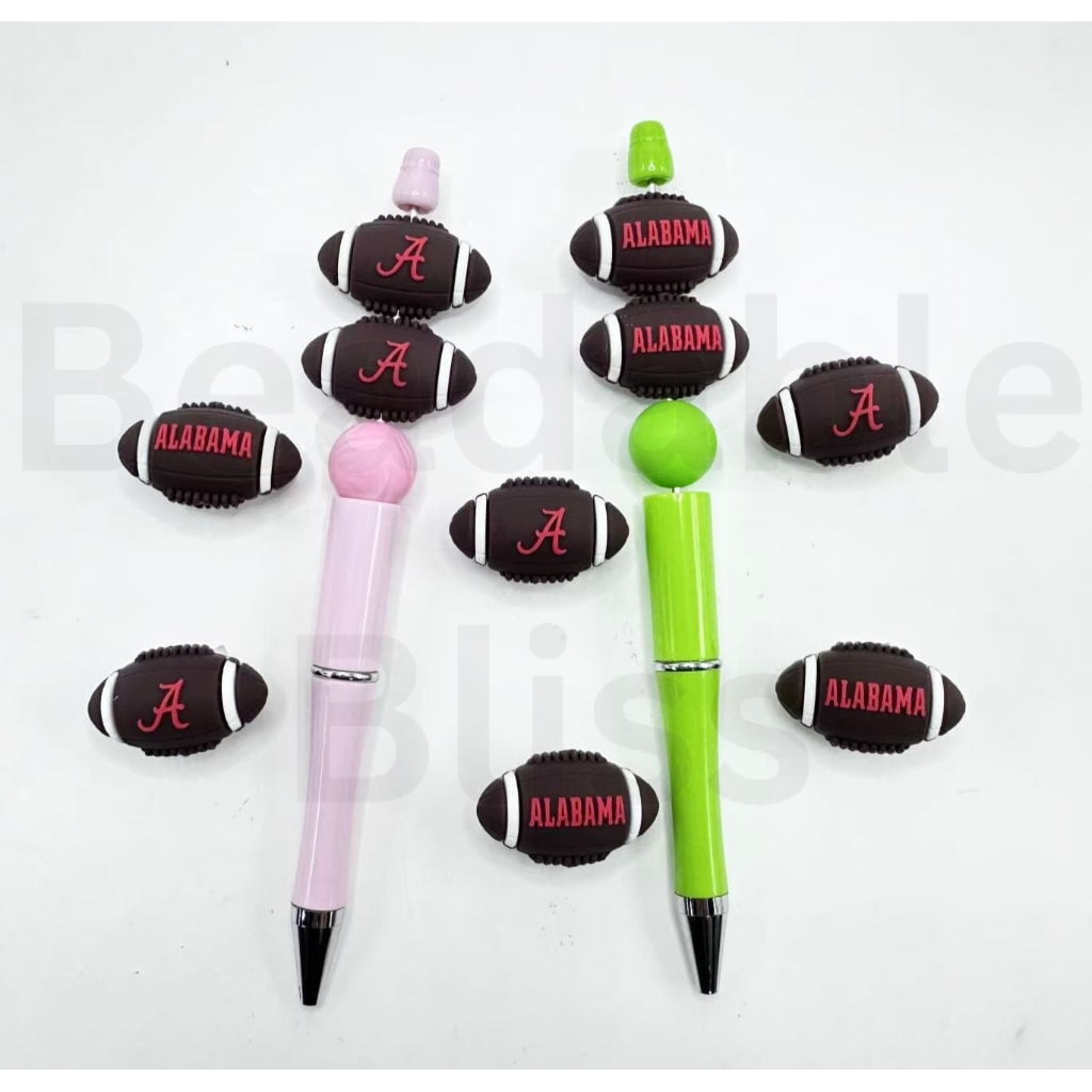 Two pens with football-shaped ends featuring 'Alabama' and a logo, on a white background.

