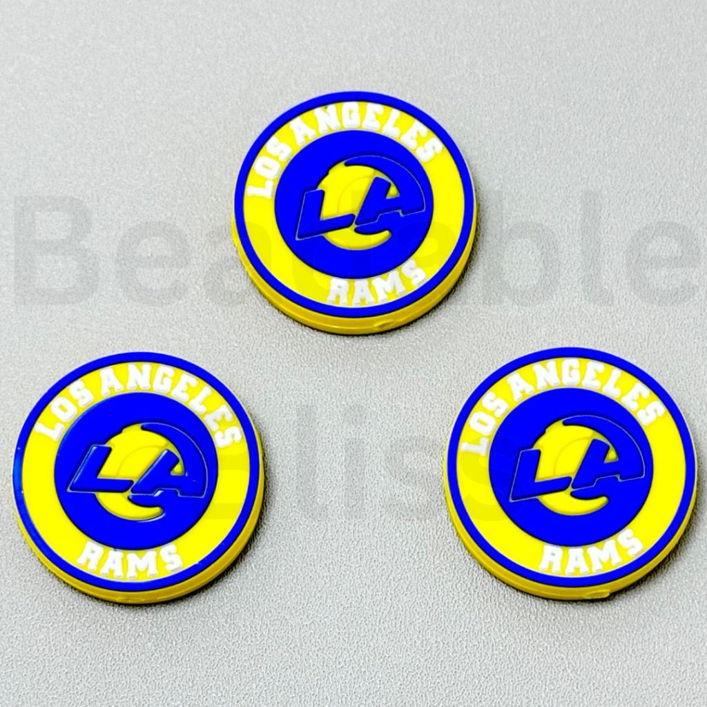 Three Los Angeles Rams logo coasters on a gray background

