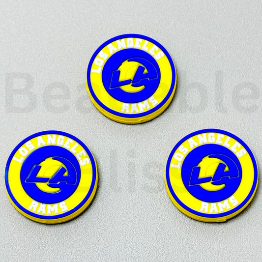 Three Los Angeles Rams logo coasters on a gray background

