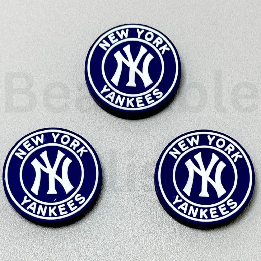 Three New York Yankees logos on a gray background

