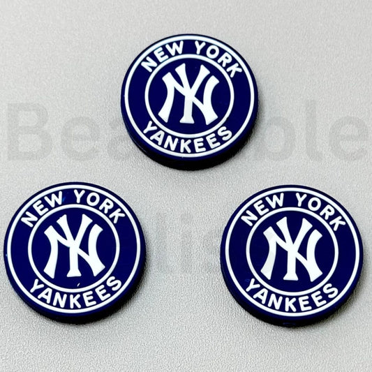 Three New York Yankees logos on a gray background


