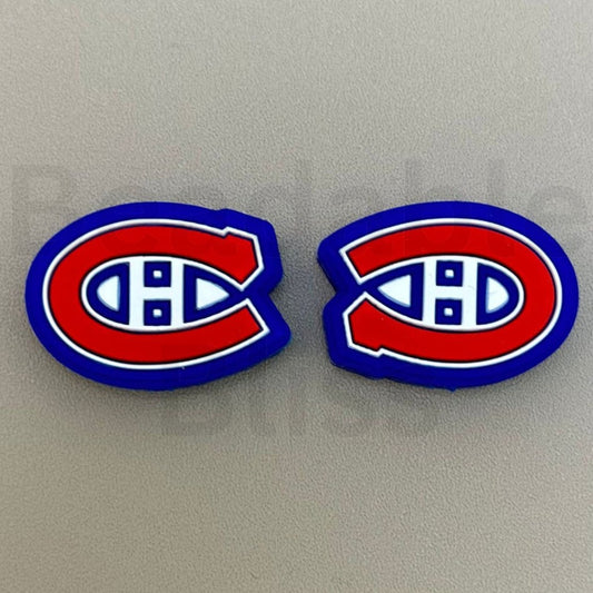 Two Montreal Canadiens logo earrings on a gray background


