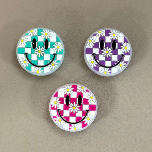 Round silicone beads with a smile face pattern and purple-white square checkers design.

