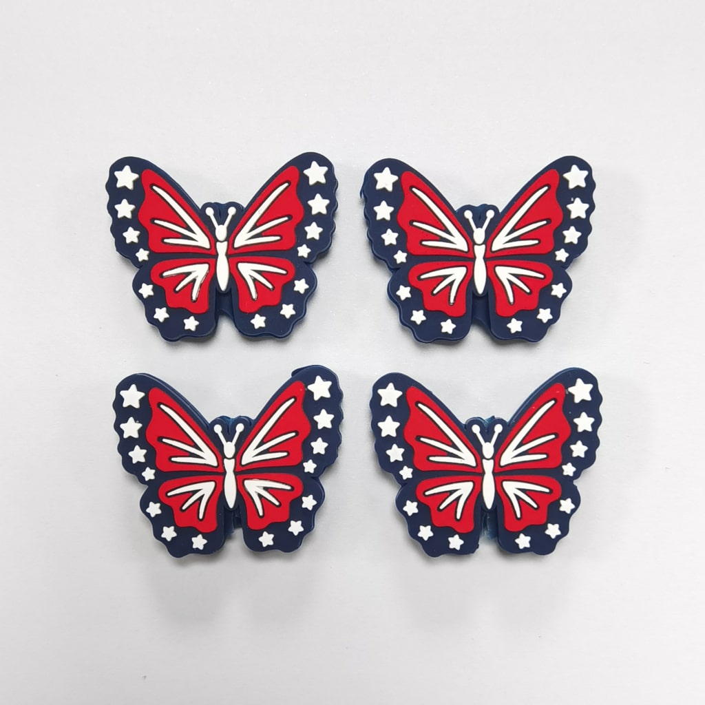 Four butterfly-shaped decorations with a red, white, and blue design on a light gray background.

