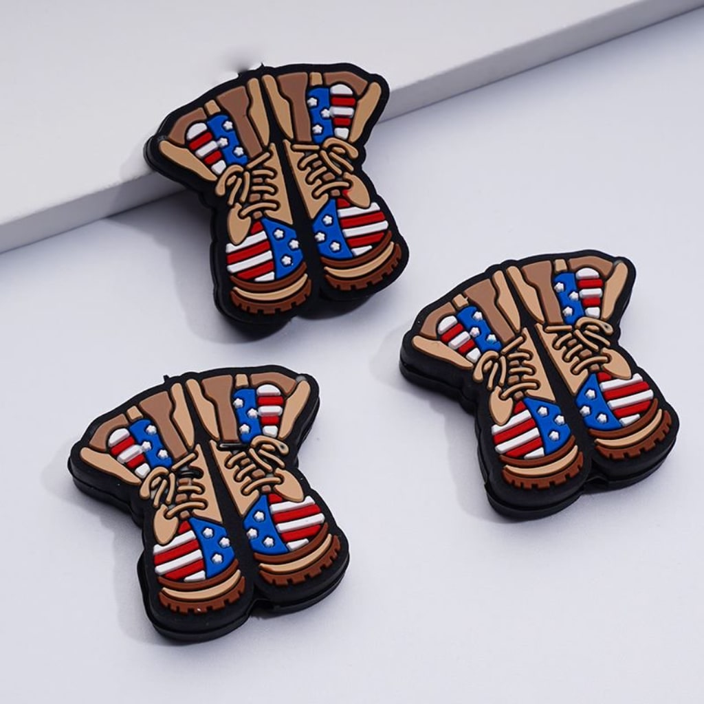 Silicone beads shaped like military army boots with a patriotic USA theme.

