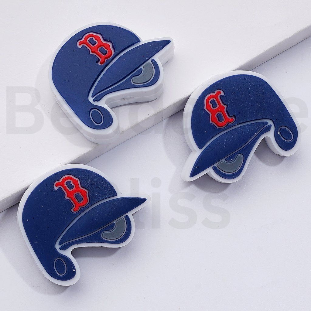 Three blue and red baseball cap-shaped objects on a white background

