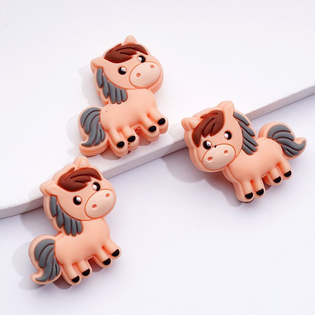 Three cartoon horse figurines on a white background

