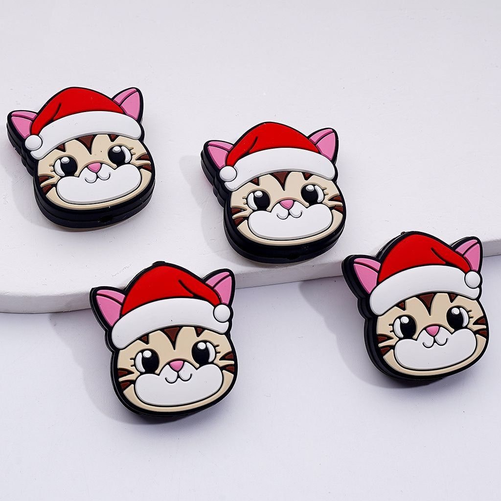 Four cartoon cat charms wearing Santa hats on a white background

