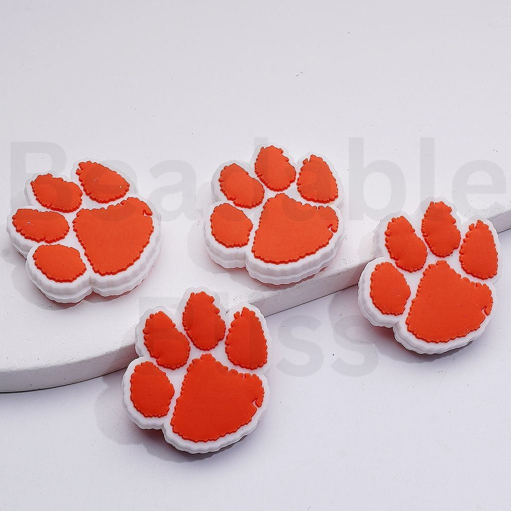 Orange paw print designs on a white background

