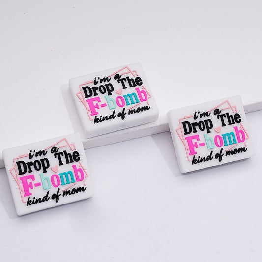 Three square coasters with humorous text design on a white surface

