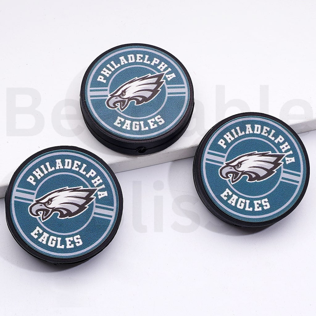 Three Philadelphia Eagles logo coasters on a white surface

