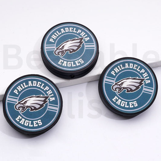 Three Philadelphia Eagles logo coasters on a white surface

