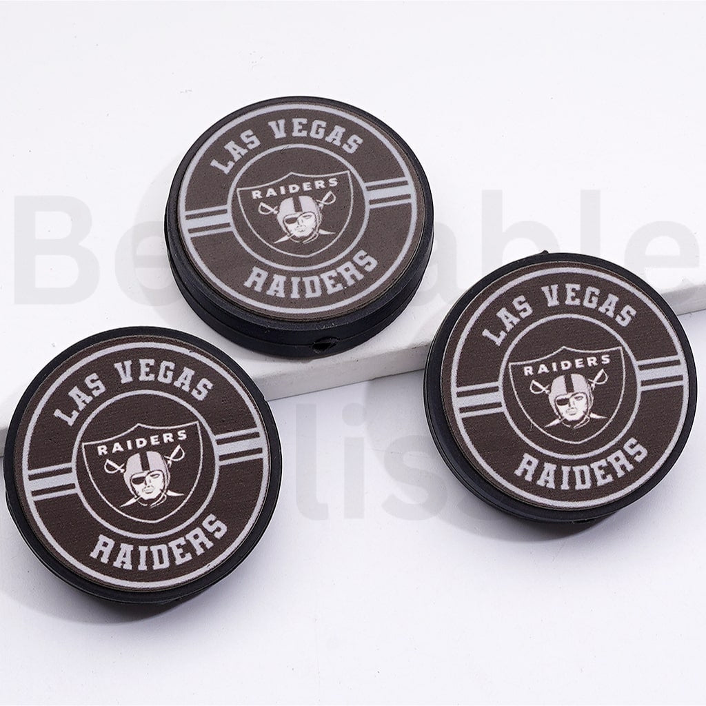 Three Las Vegas Raiders logo coasters on a white background

