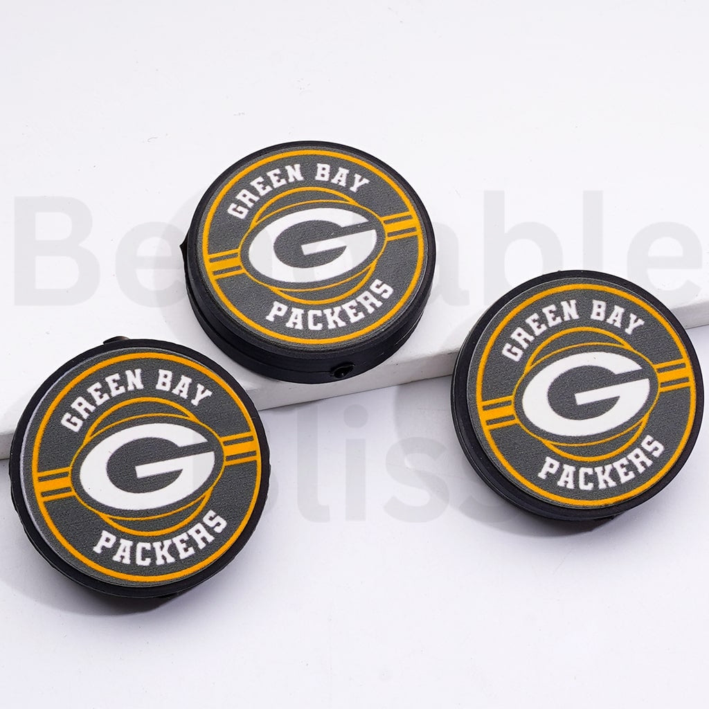 Three Green Bay Packers bottle caps on a white background

