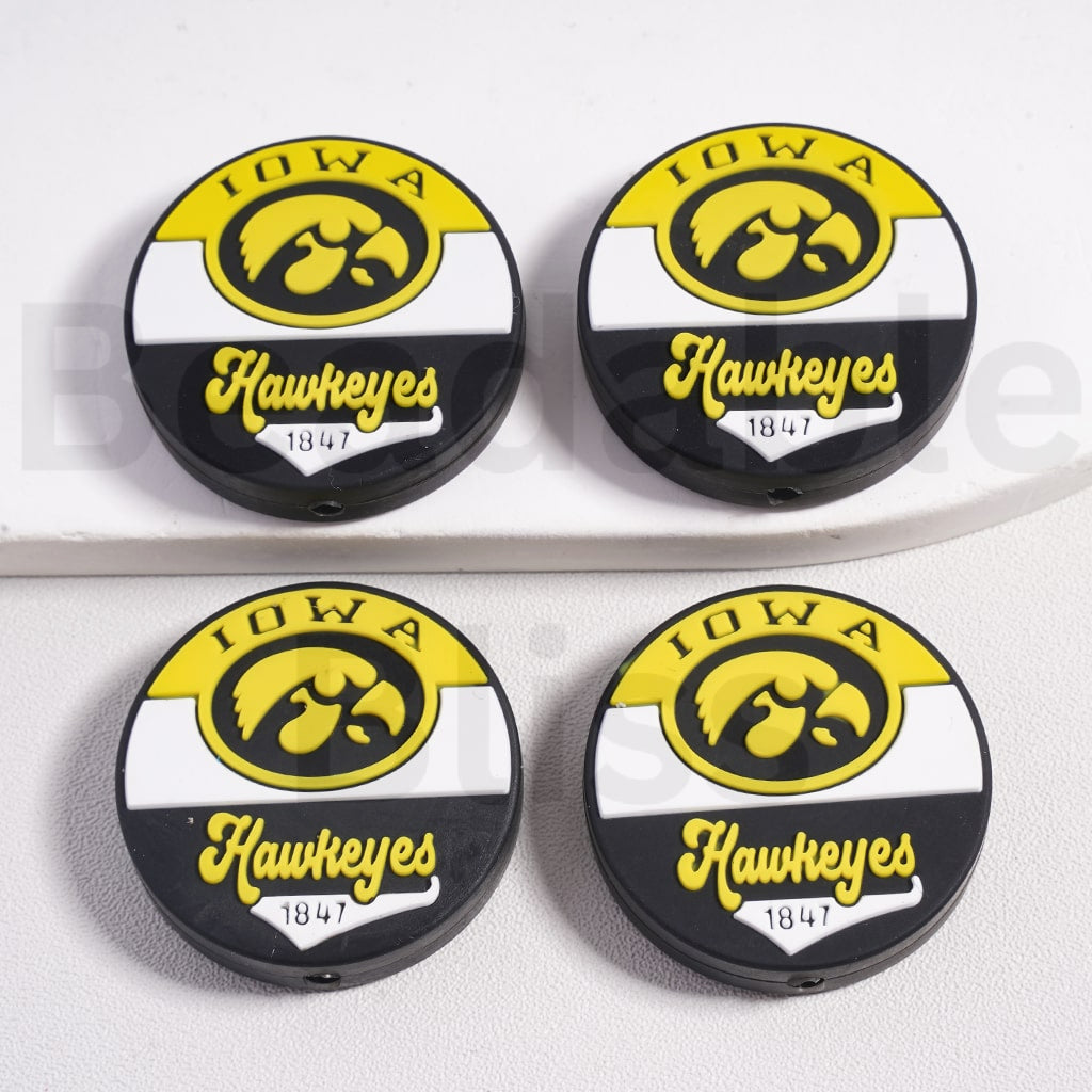 Four Iowa Hawkeyes logo coasters on a white background

