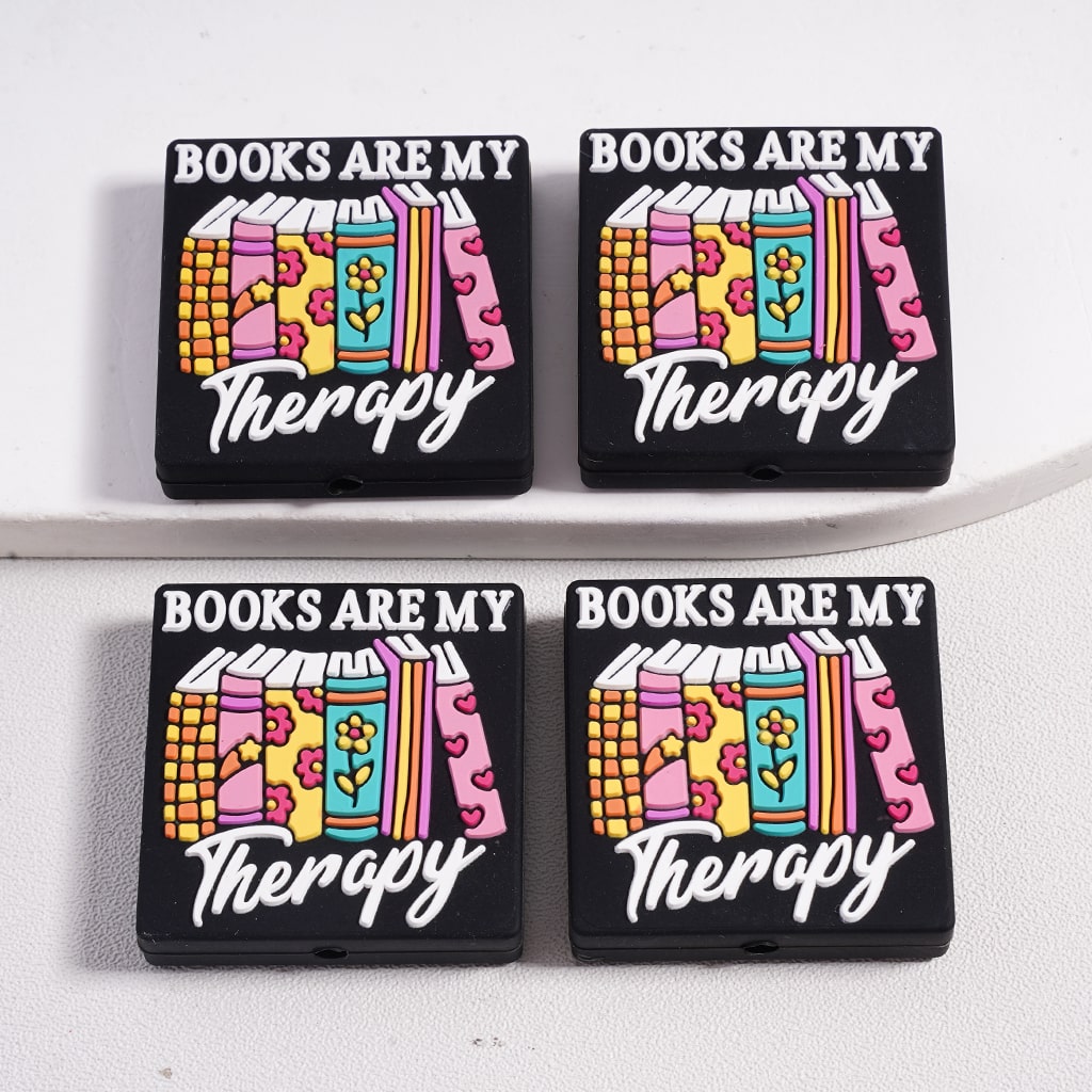 Four black rectangular objects with colorful book illustrations and 'Books are my Therapy' text on a white background.

