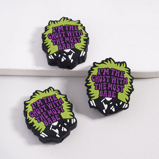 Three ghost-shaped pins with text on a white background

