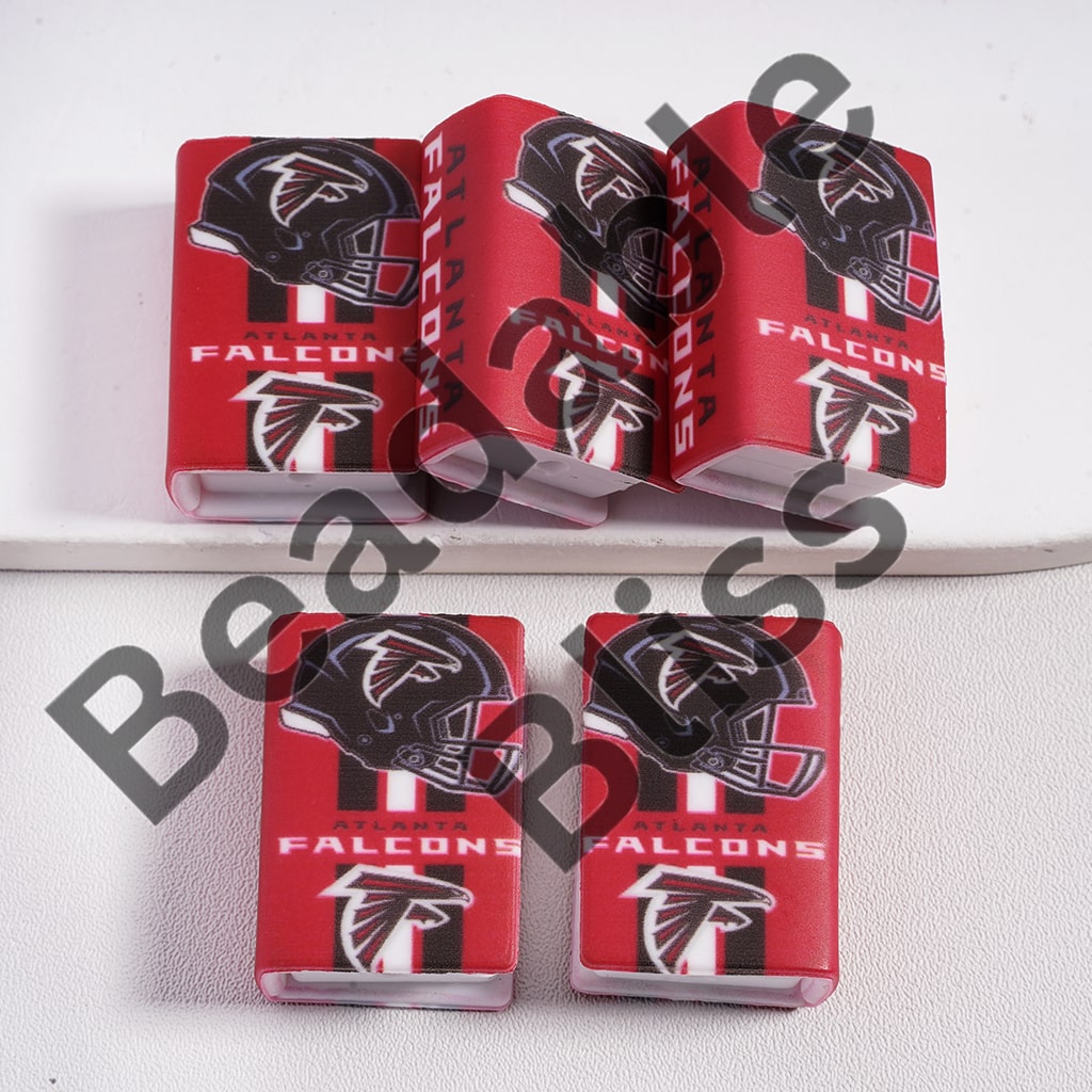 Five red Atlanta Falcons-themed phone cases on a white surface.

