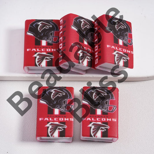 Five red Atlanta Falcons-themed phone cases on a white surface.

