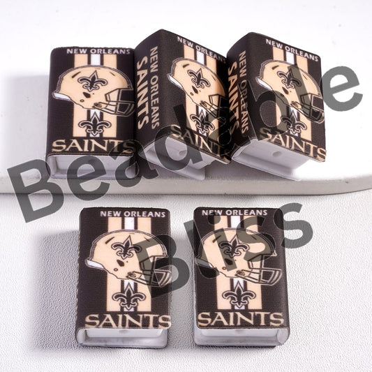 New Orleans Saints-themed dice set on a white background

