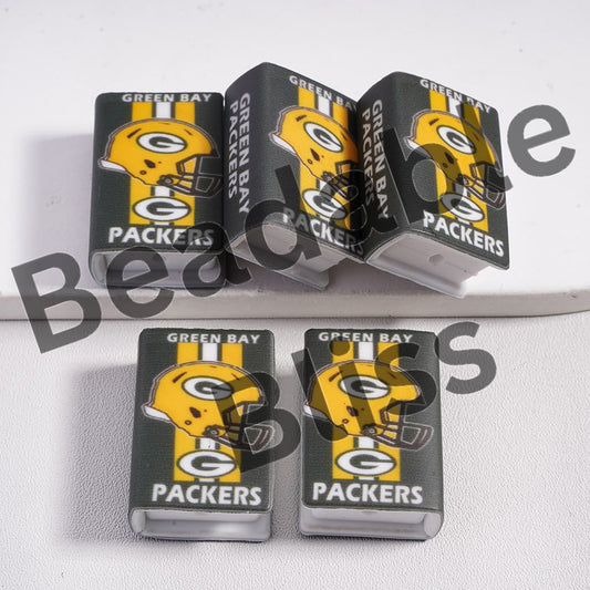 Green Bay Packers-themed items including a box and a helmet design on a white background.

