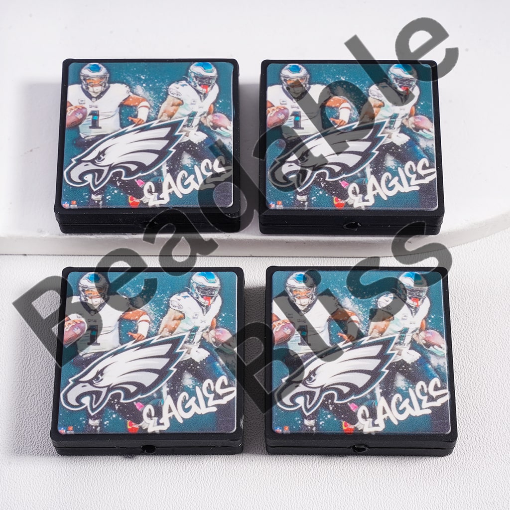 Four Philadelphia Eagles-themed coasters on a white surface.

