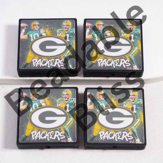 Four Green Bay Packers coasters with a player holding a football on a white background.
