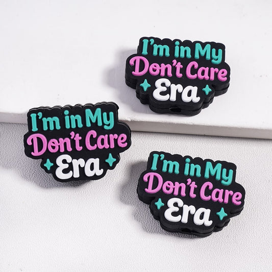 Three 'I'm in My Don't Care Era' rubber bands on a white background

