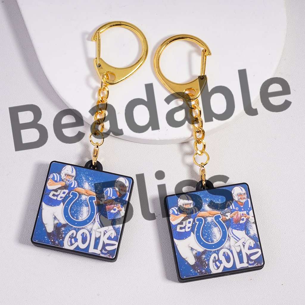 Pair of keychains with sports team design on a white background