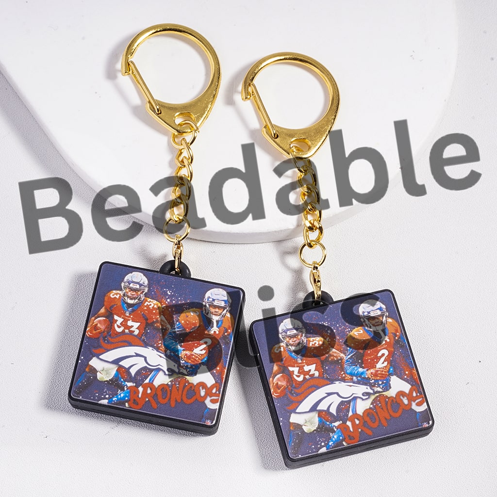Keychains with Broncos logo and player images on a white background