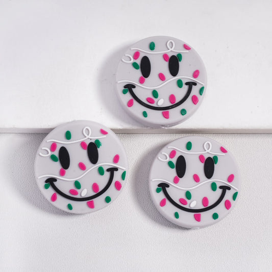 Three round buttons with smiley face designs on a white background