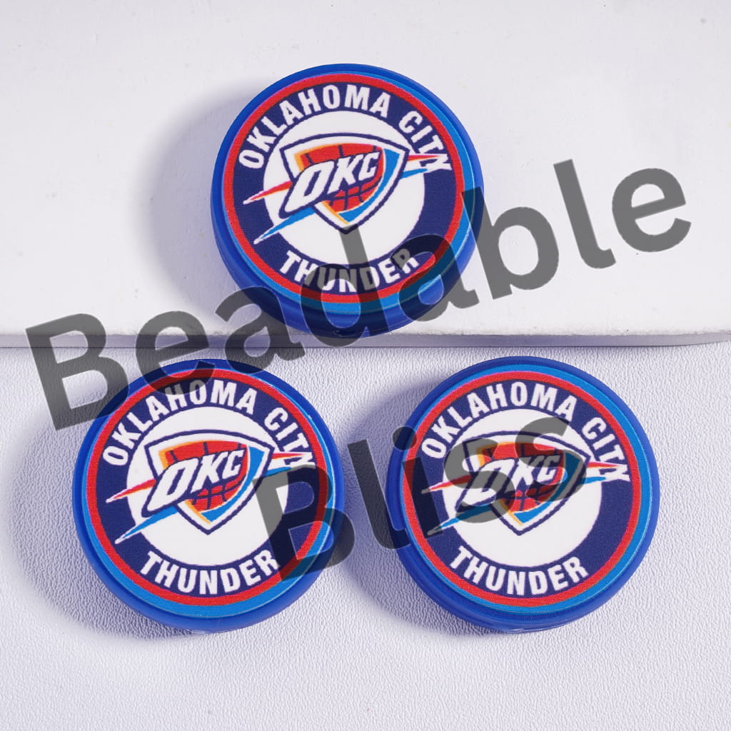 Three Oklahoma City Thunder bottle caps on a white background