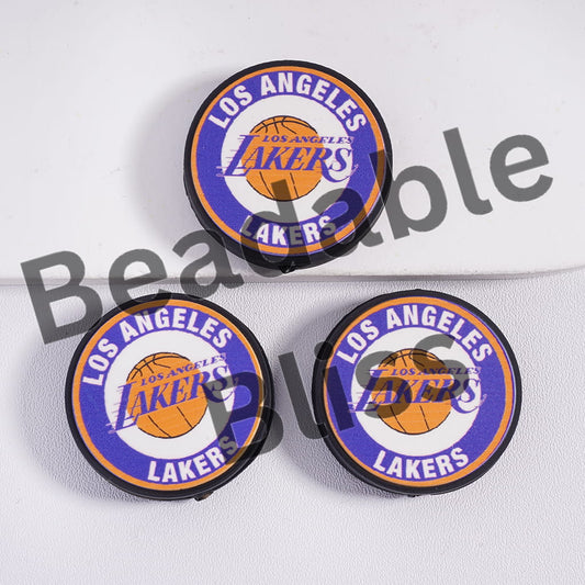 Three Los Angeles Lakers logo coasters on a white background