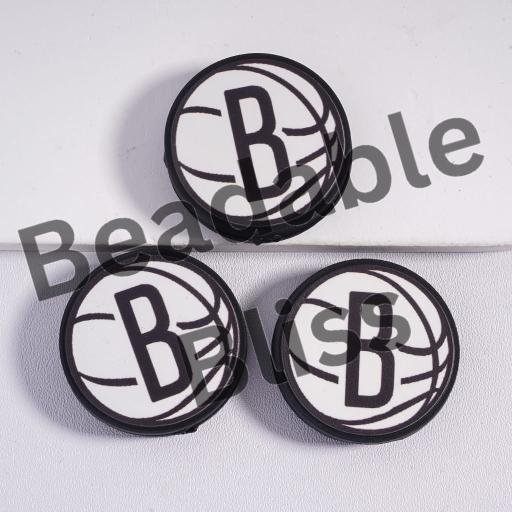 Three circular black and white cutout designs with a letter 'B' on a light gray background.