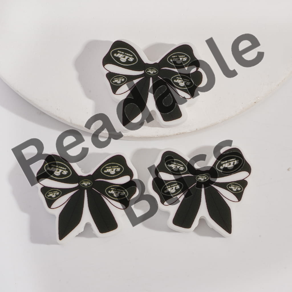 Black and white bow-shaped earrings with a logo on a light gray background, branded 'handsontosupply'.