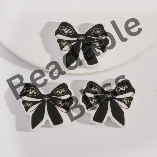 Black and white bow-shaped earrings with a logo on a light gray background, branded 'handsontosupply'.