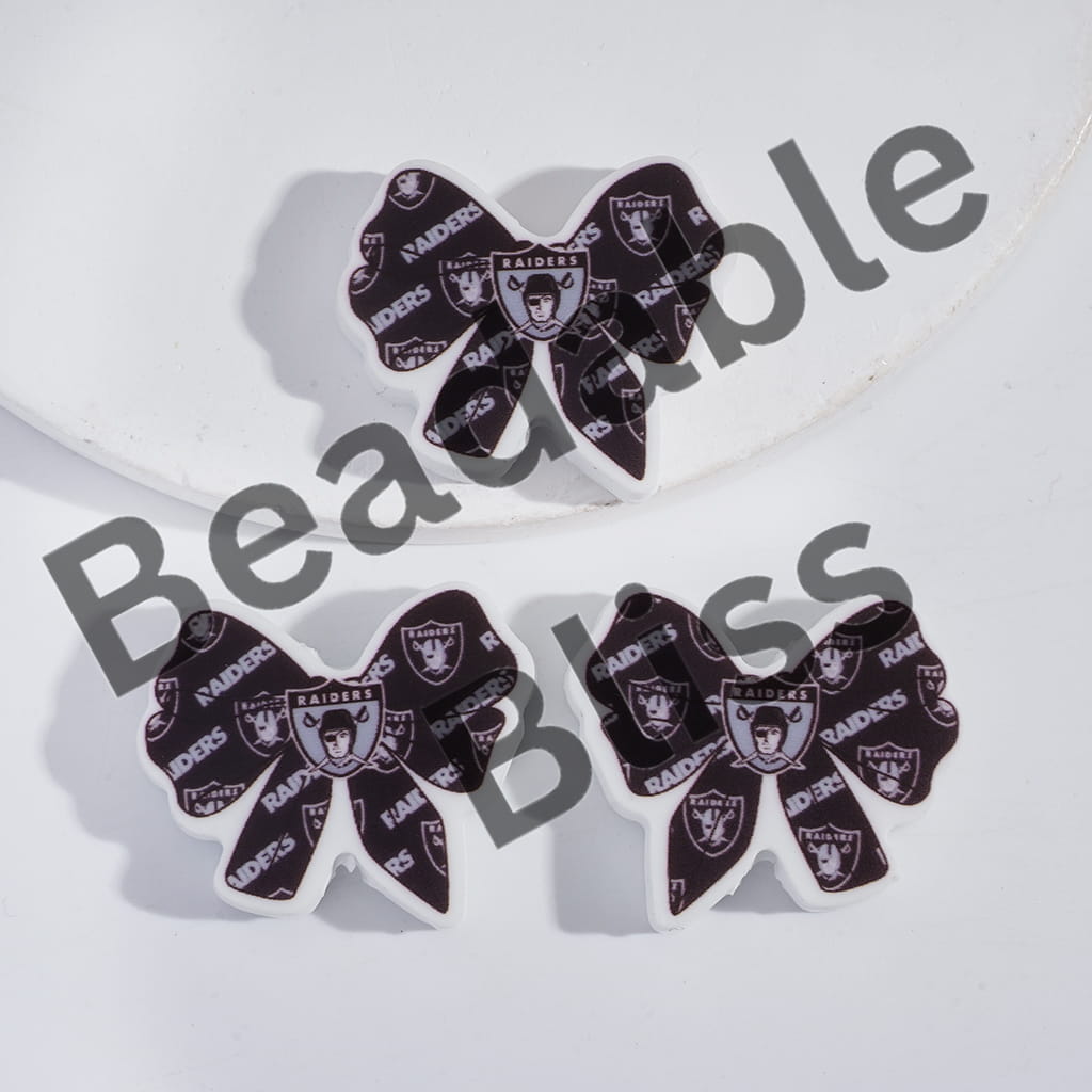 Three decorative bows with Oakland Raiders logo on a white background, branded 'handsontosupply'.