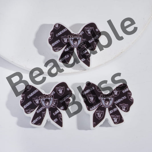Three decorative bows with Oakland Raiders logo on a white background, branded 'handsontosupply'.