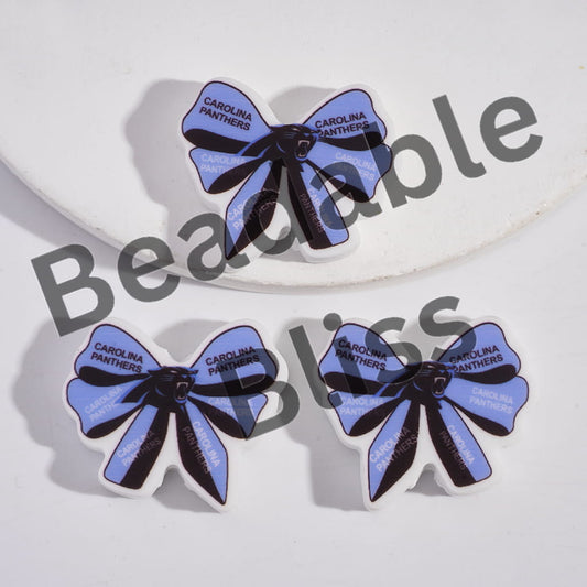 Carolina Panthers-themed bow-shaped earrings on a white background with 'handsoffisupply.' branding.