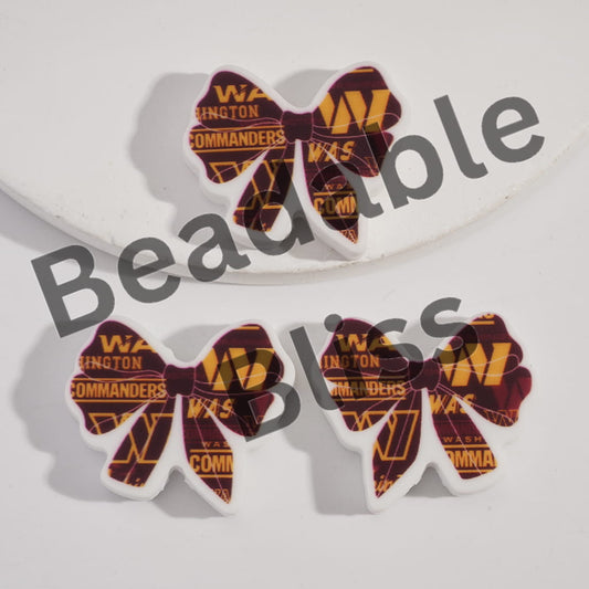 Three decorative bows with 'Washington Commanders' text on a white background, branded 'handsontupply'.