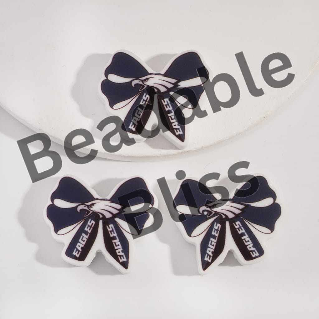Bow-shaped earrings with 'Eagles' text on a white background