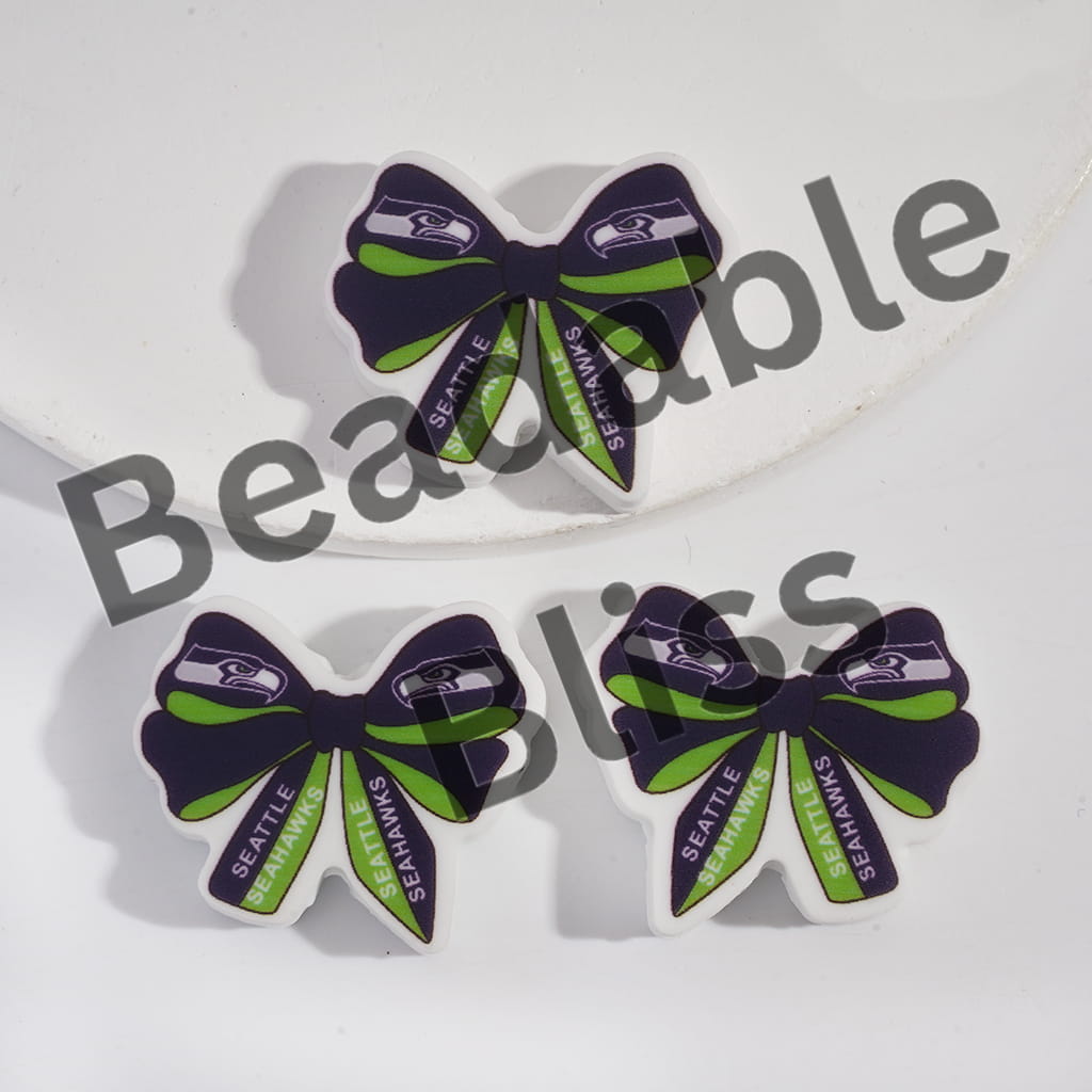 Three bow-shaped car air fresheners with Seattle Seahawks logo on a white background.