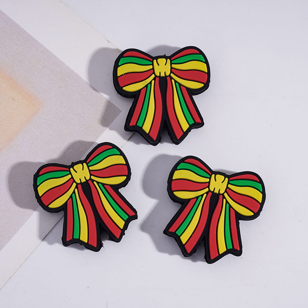 Three colorful bow-shaped objects on a light background