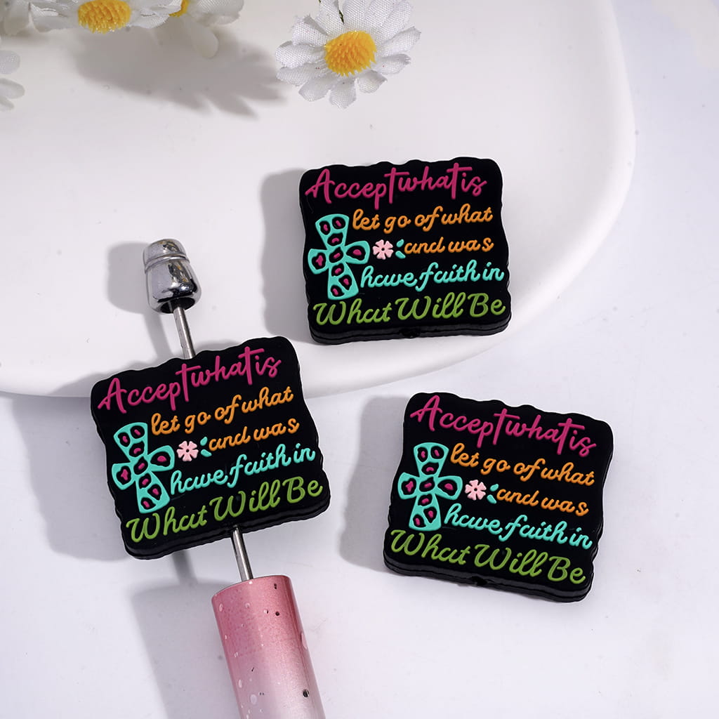 Silicone Focal Beads with Text "Accept what is, let go of what was, and have faith in What Will Be" and Cross Pink Flower on Black Background