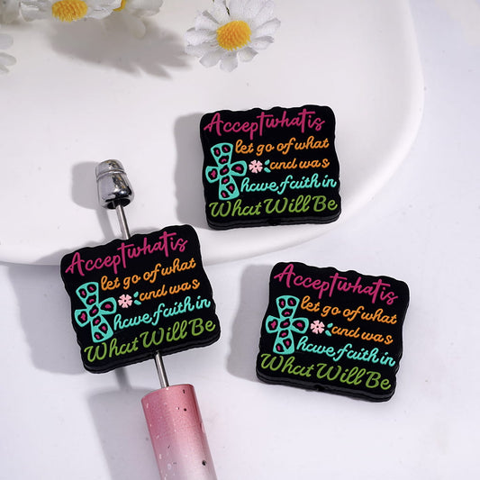 Silicone Focal Beads with Text "Accept what is, let go of what was, and have faith in What Will Be" and Cross Pink Flower on Black Background